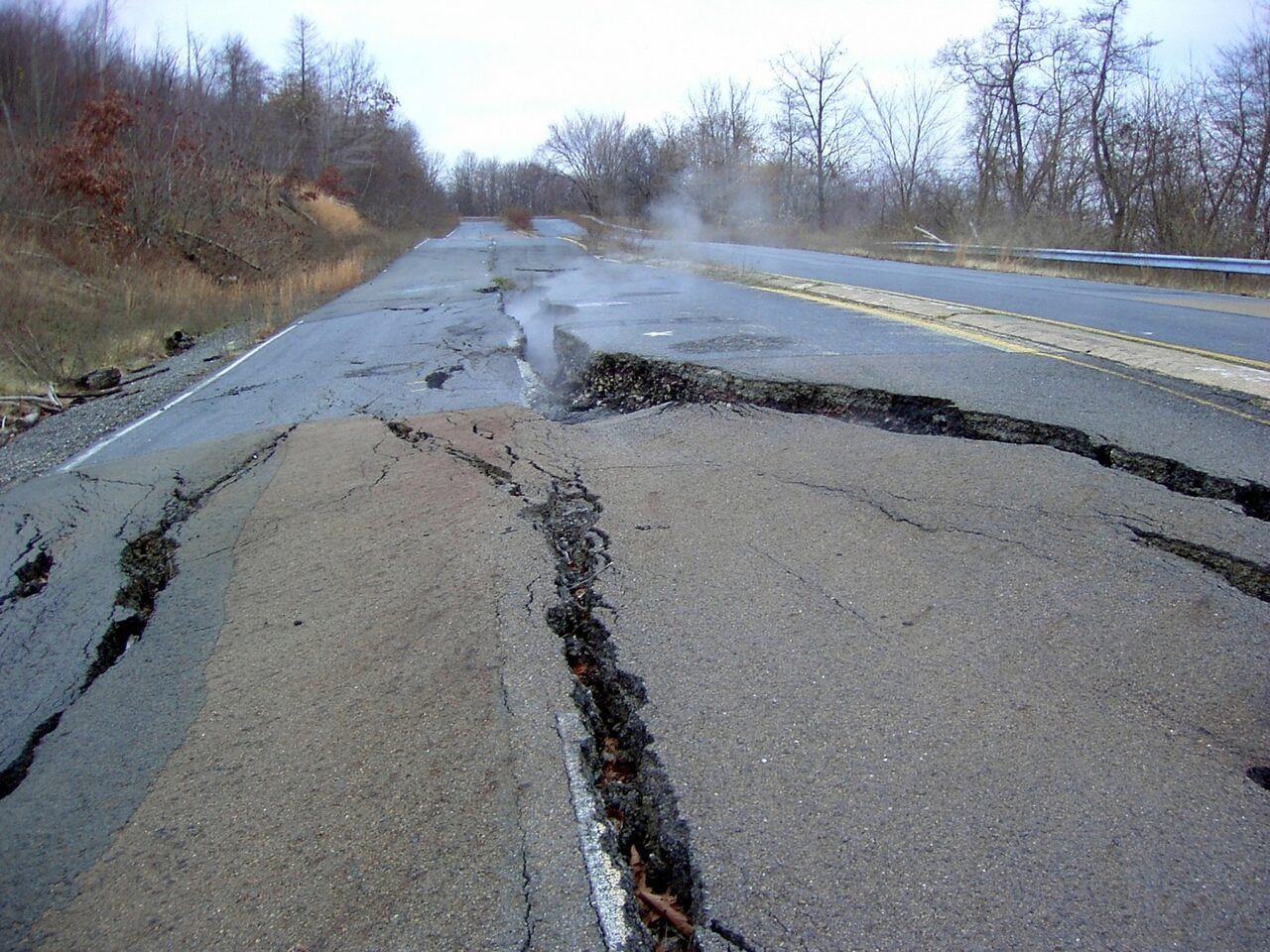 The closed section of Route 61 around 2006, split down the middle and steaming, with its replacement running alongside.
