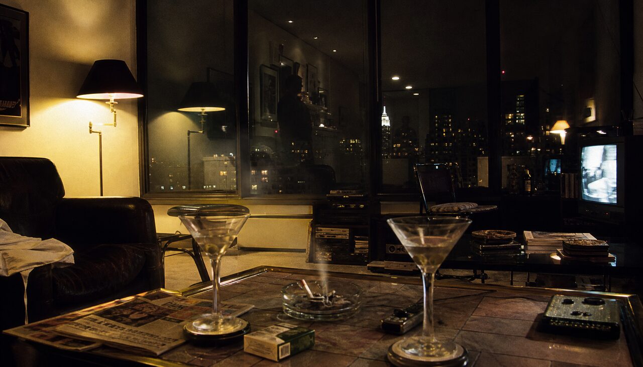 A wired apartment, a mirror, two unfinished drinks. The observation was the point.