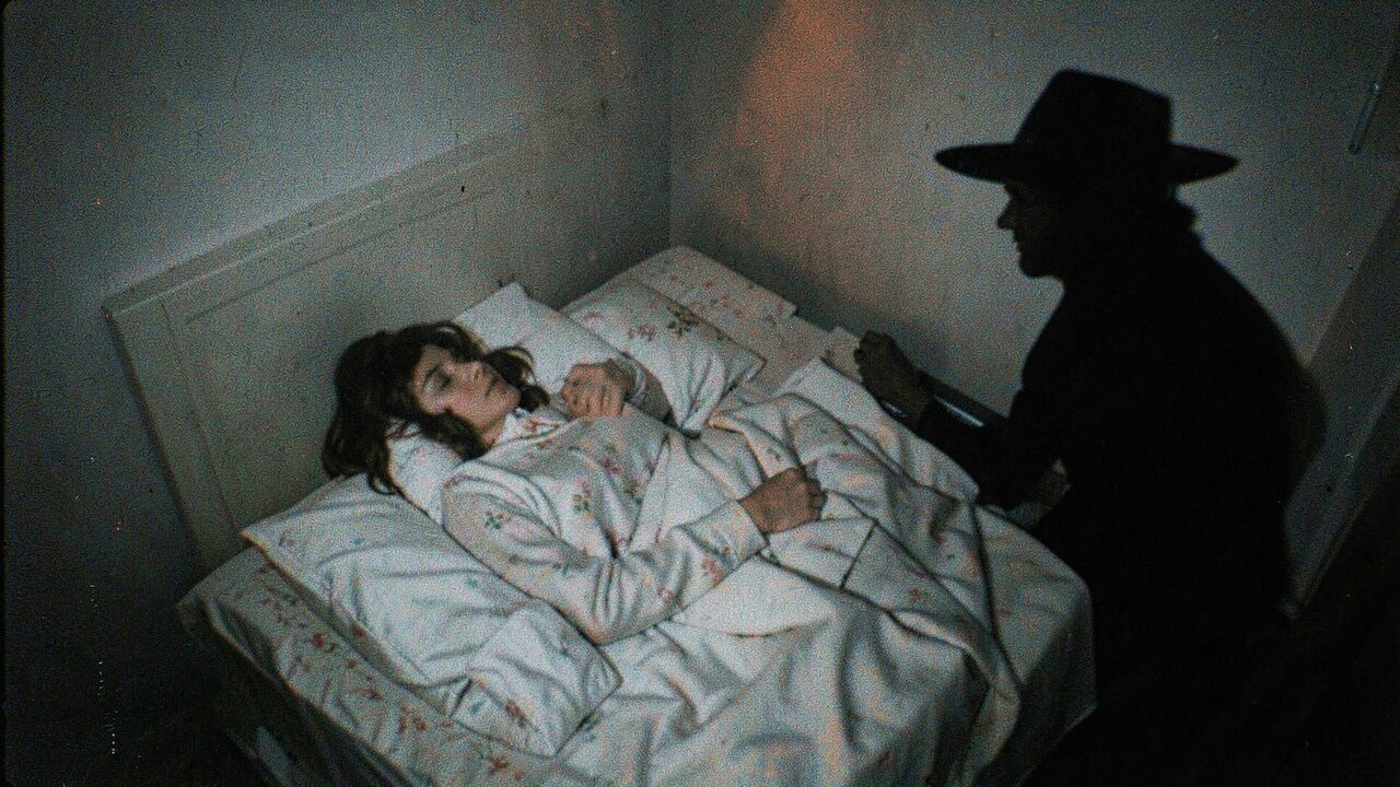 A high-angle view: a sleeper in bed, and a dark figure in a wide-brimmed hat standing in the corner of the room. Witnesses report the certainty of being watched.