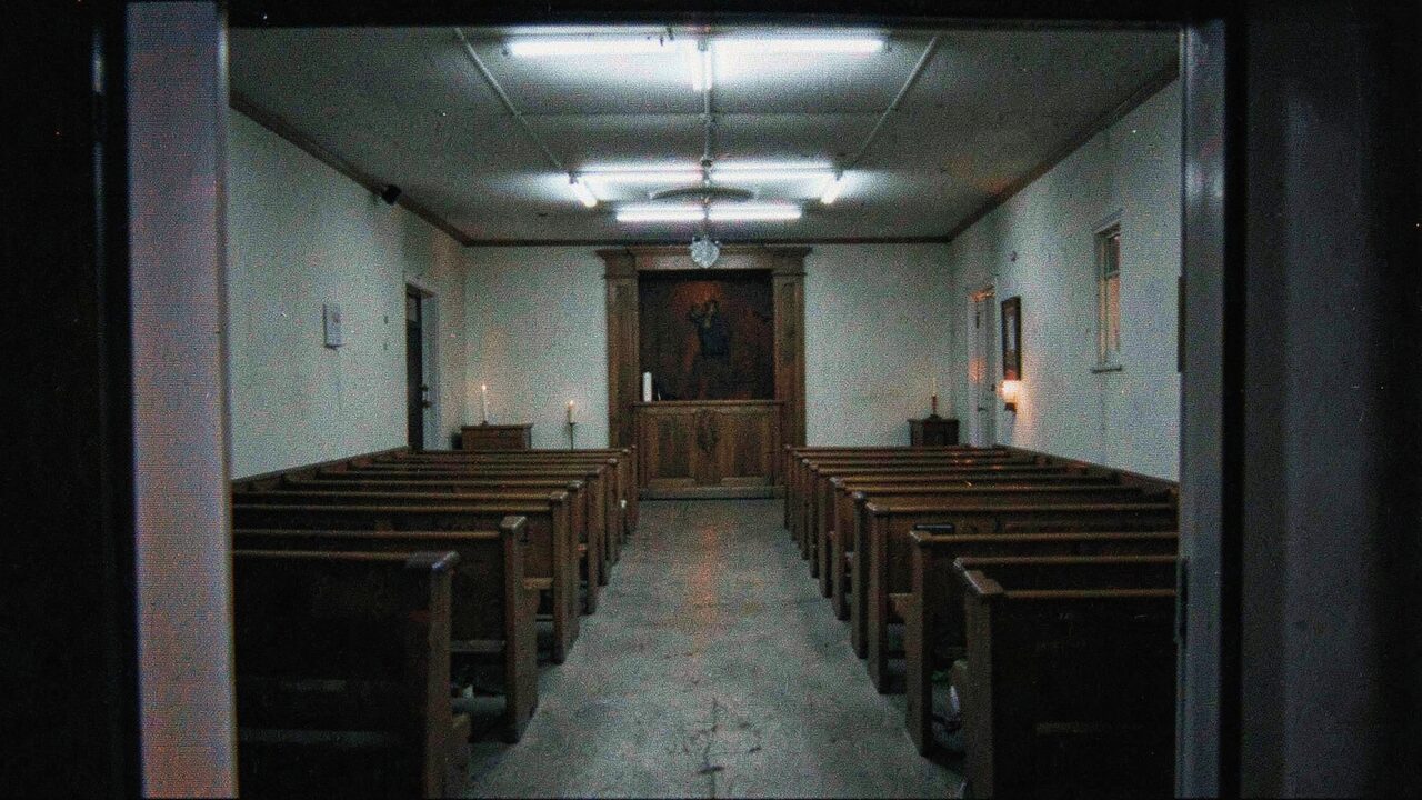 A small synagogue, empty. The tradition is real and old. The cabinet is neither.