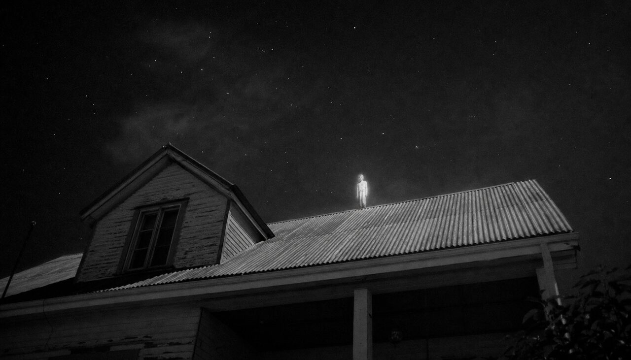 A figure on the tin roof. The witnesses insisted it did not fall so much as drift.