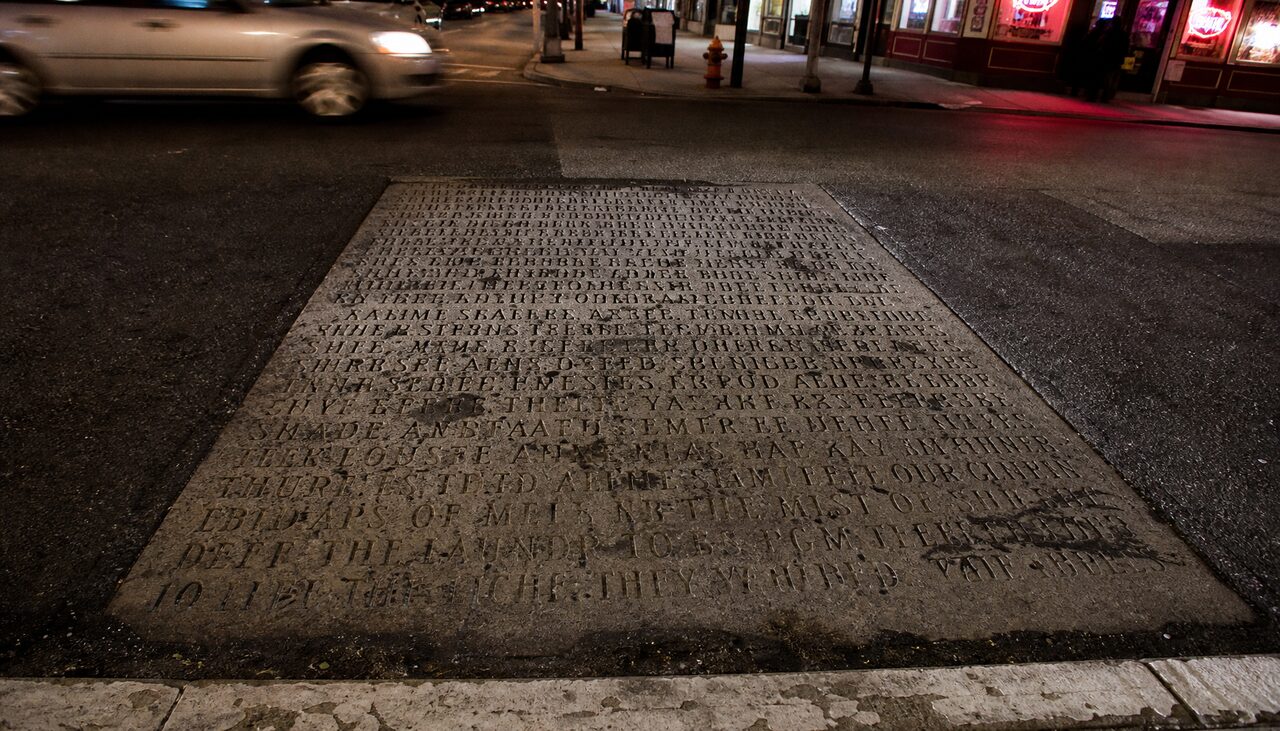 A manifesto tile, dense and worn. The carving got tighter as the worldview got larger.